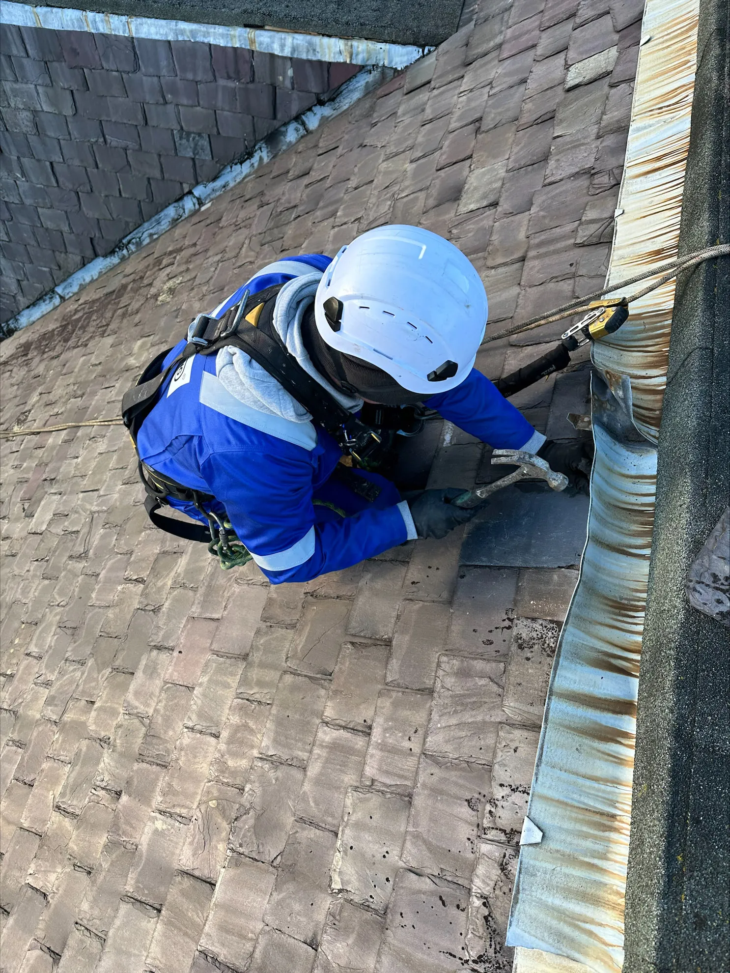 Slate repair carried out by rope access