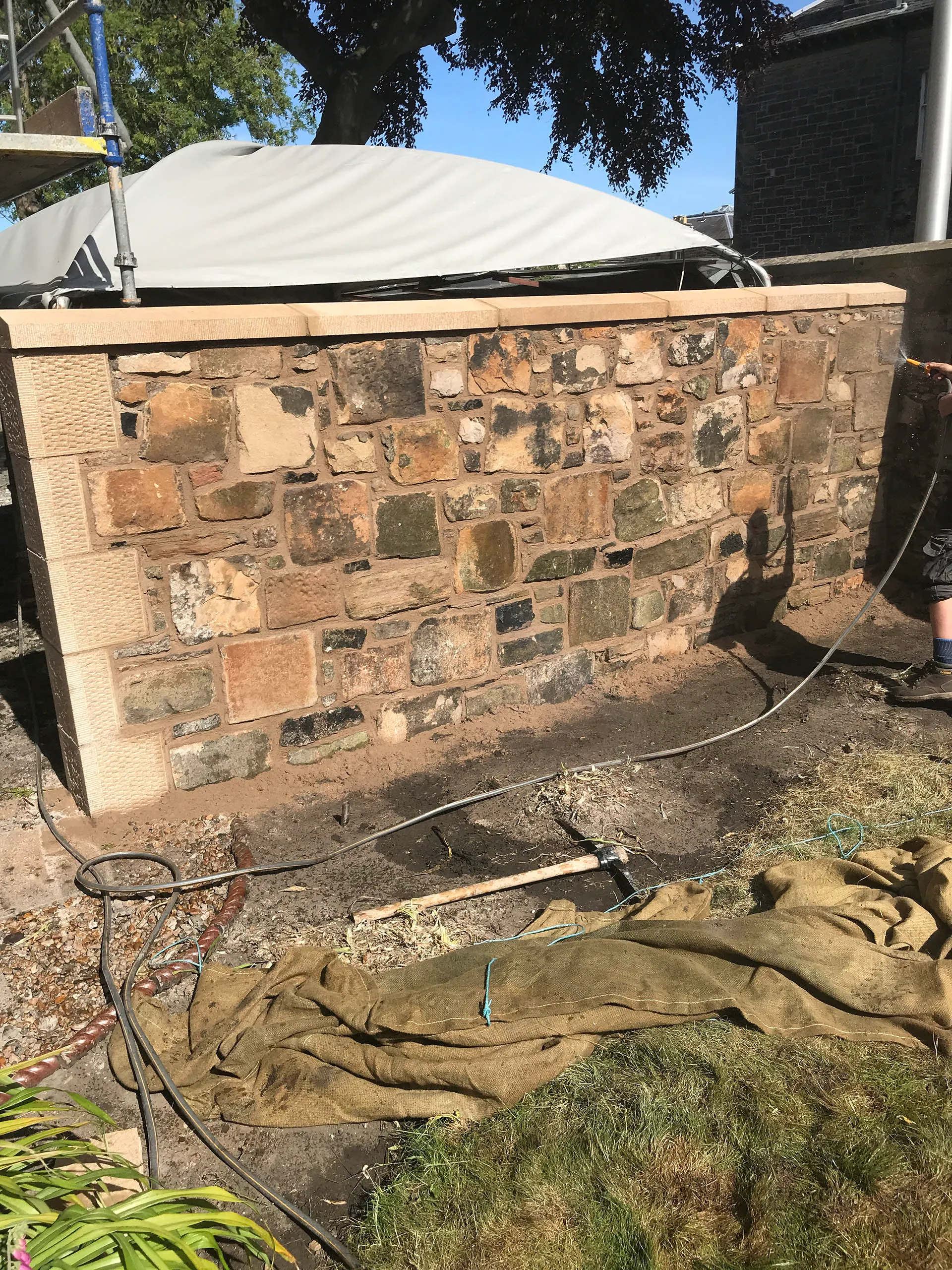 Long stretch of rubble stone wall after lime repointing
