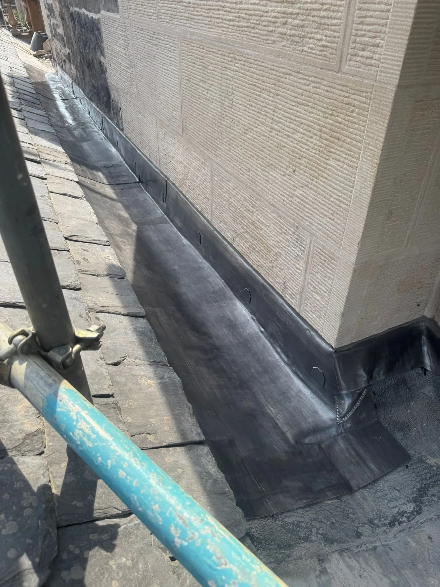 New lead flashing where a slate roof meets a stone wall