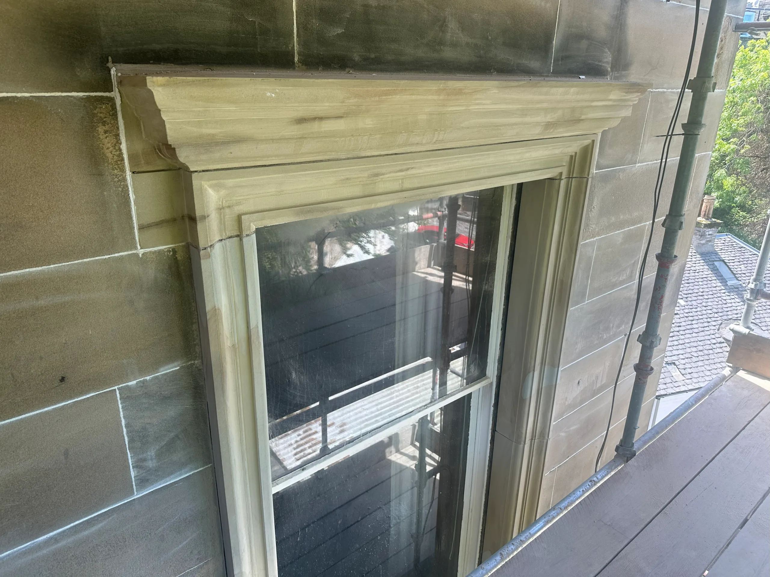 Newly replaced sandstone window surround in clean dressed stone