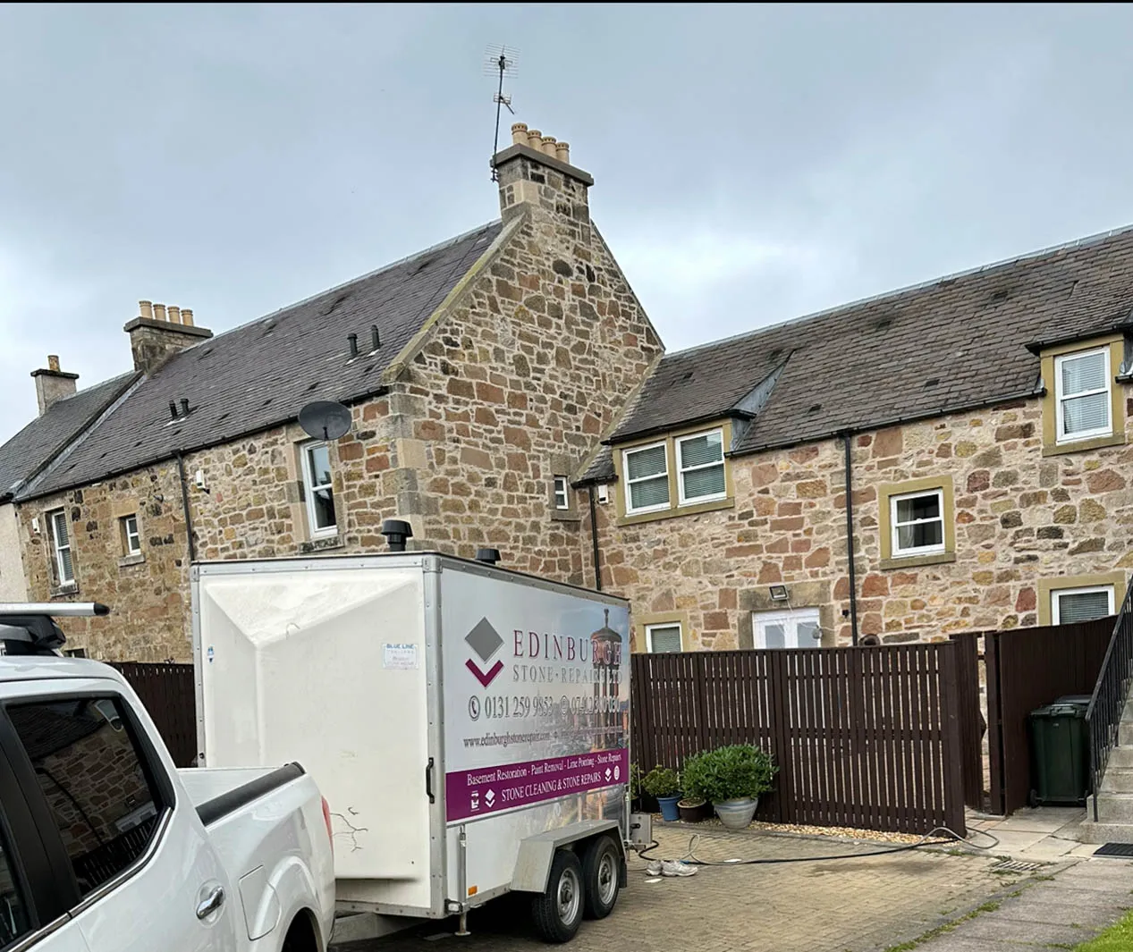 Edinburgh Stone Repair van and trailer parked outside a stone house
