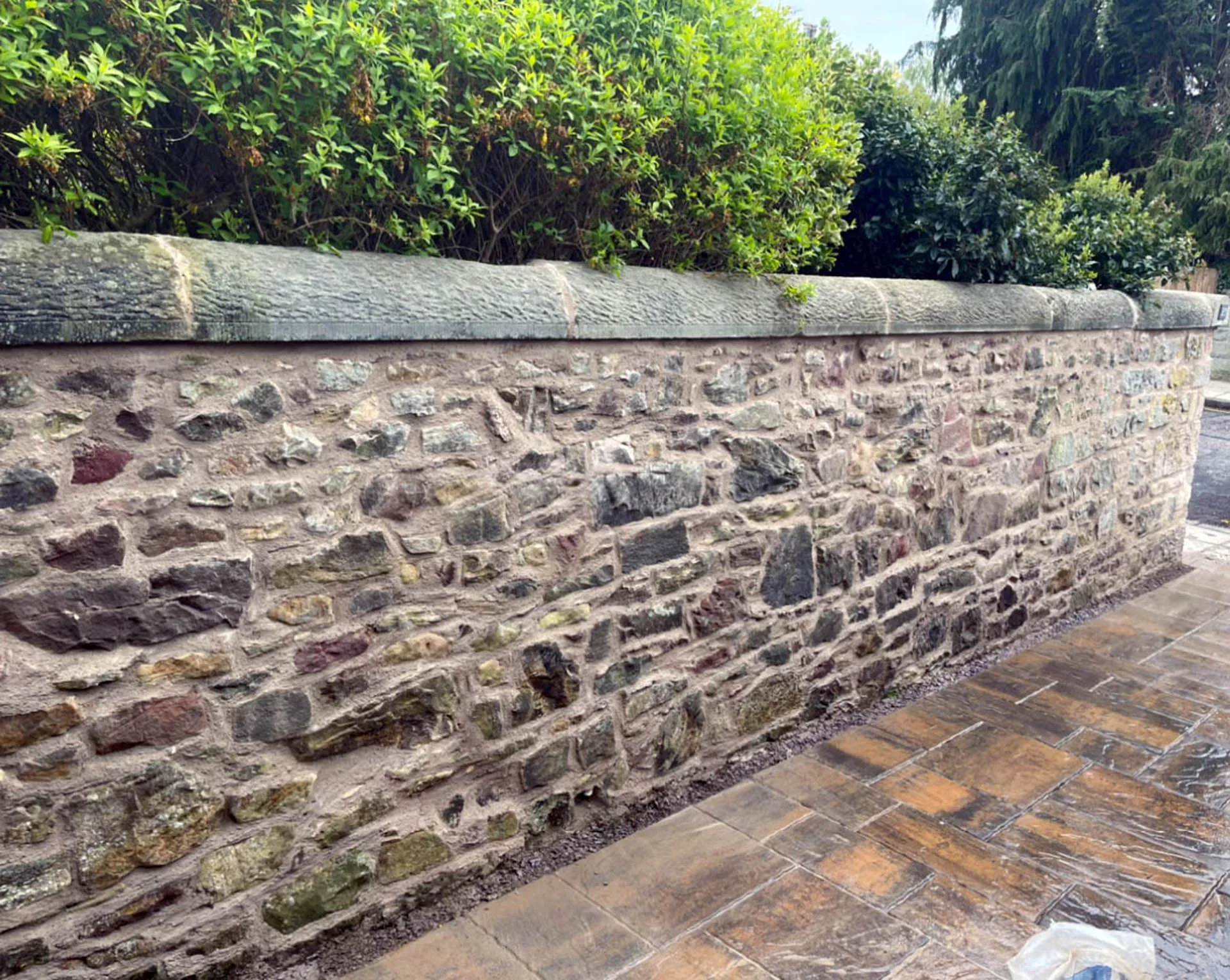 Rubble stone wall with freshly raked and pointed lime mortar joints