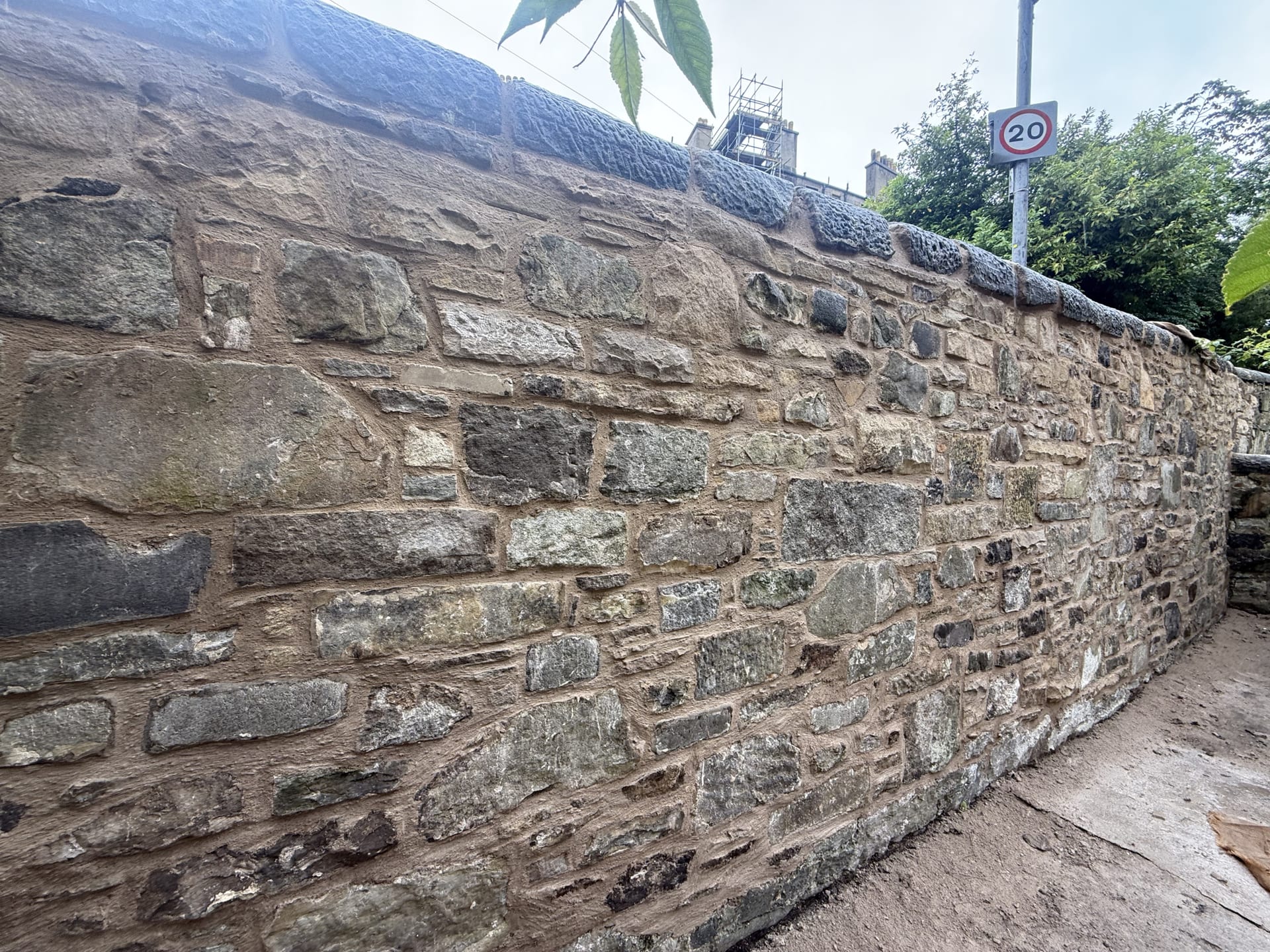 Close view of a rubble stone wall with newly finished lime pointing