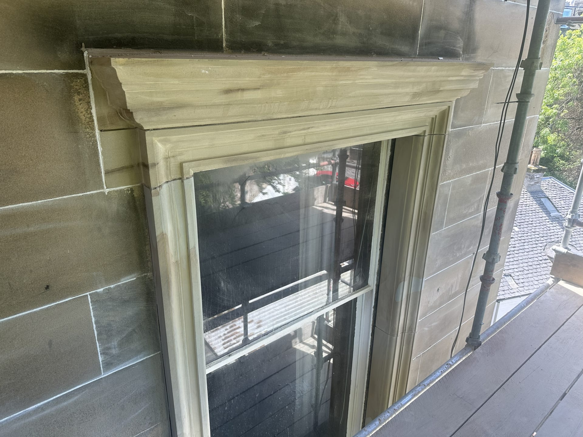 Newly replaced sandstone window surround in clean dressed stone