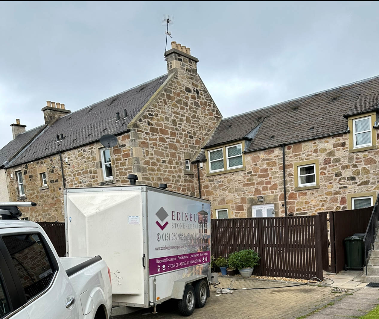 Edinburgh Stone Repair van and trailer parked outside a stone house